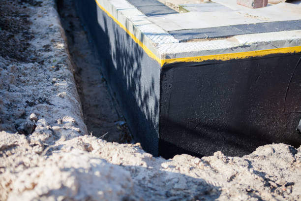 Professional Basement Waterproofing technician working in Valley Center, KS